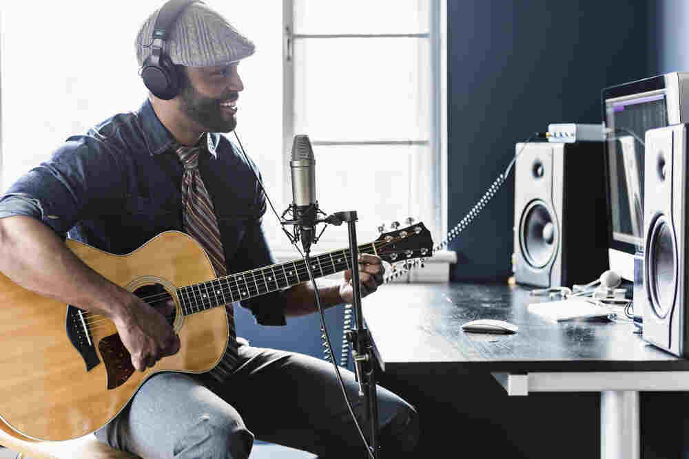 Home recording musician playing guitar