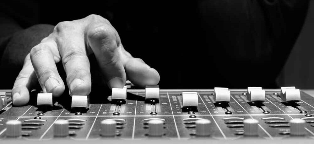 Sound engineer hands adjusting control