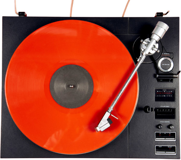 Red vinyl record on turntable