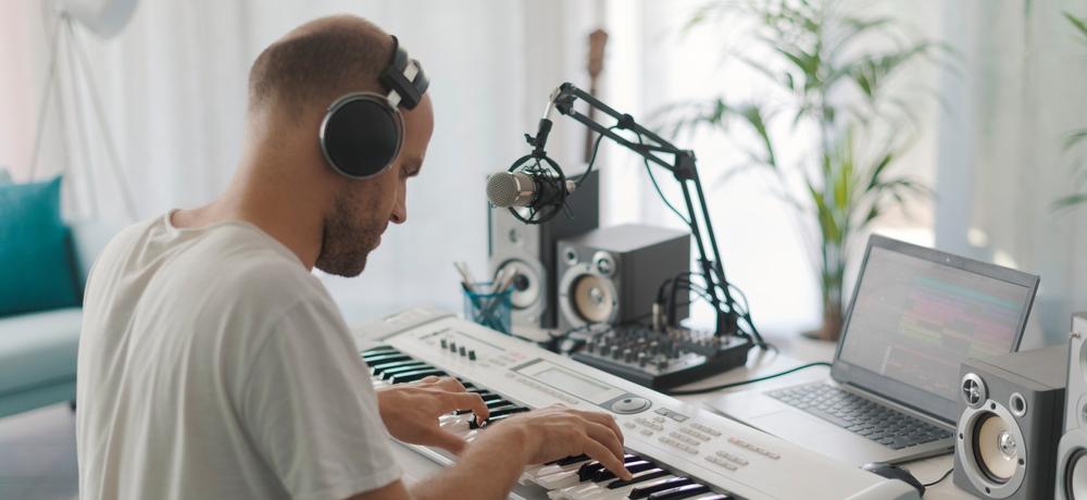A man composing his own music at home
